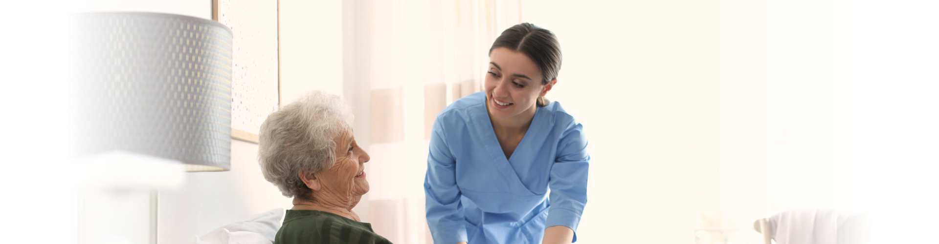 Care worker with elderly woman in geriatric hospice